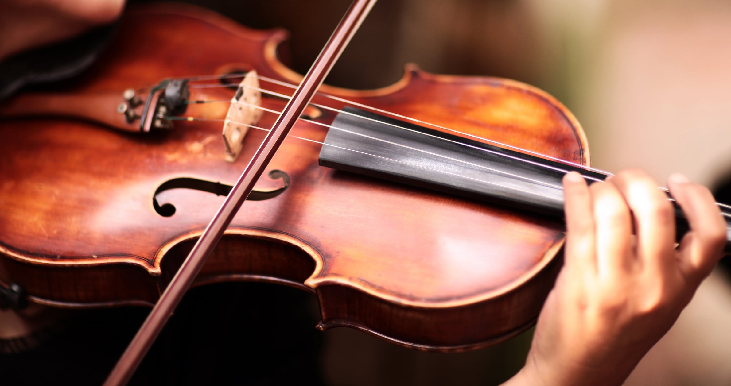 Person playing a violin close-up