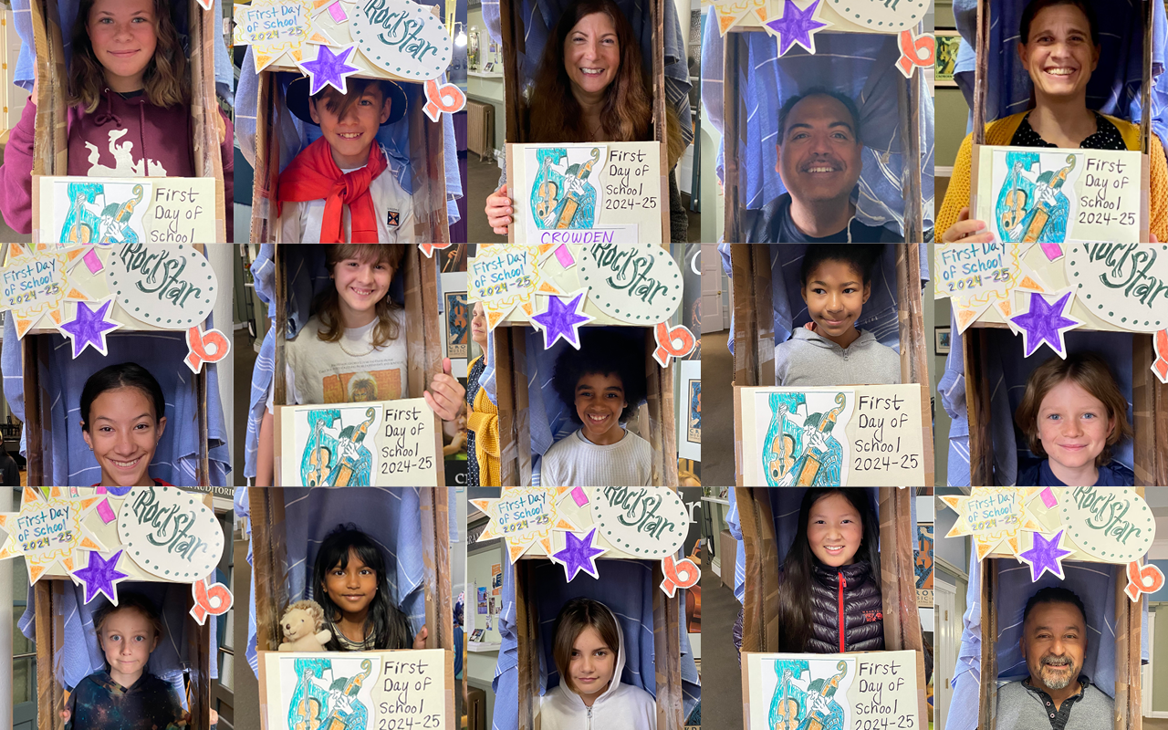 Crowden School students, faculty, and staff pose inside of a DIY cardboard 'photo booth'