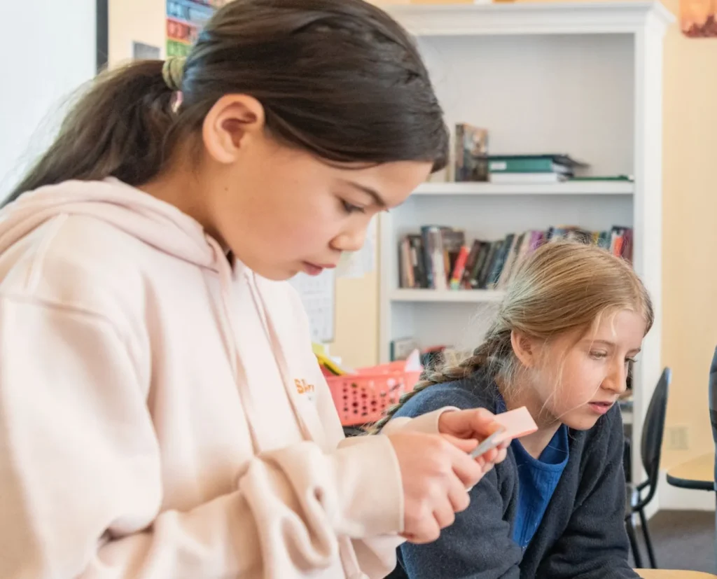 Students reading and discussing in classroom
