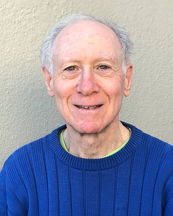 Elderly man smiling in blue sweater