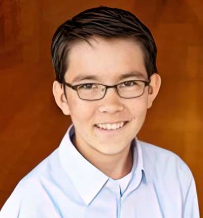 Smiling person with glasses and short hair