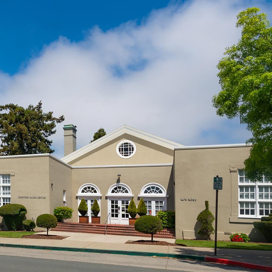 Historic music center building with trees and sky