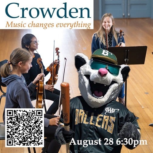 Crowden music event with mascot and musicians.