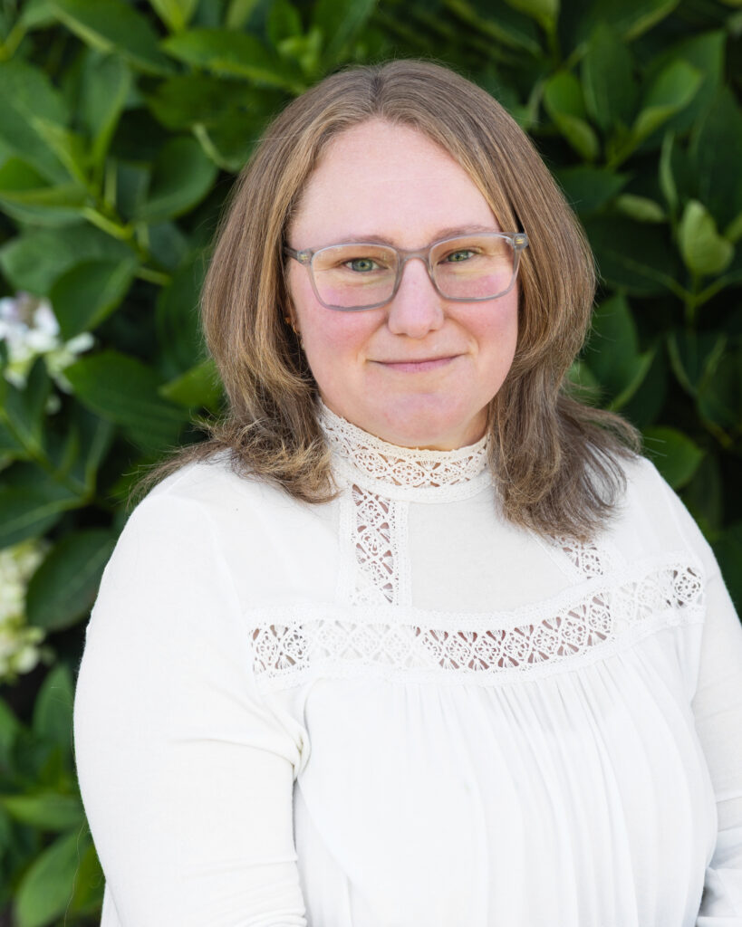 Woman in white blouse with green backdrop