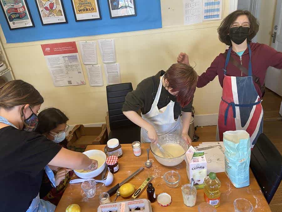 Group cooking together in kitchen class