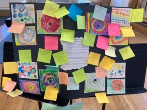 Colorful art display with sticky notes on board.