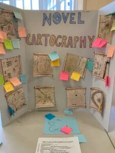Exhibit on novel cartography with maps and notes.