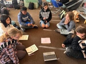 Students sitting in circle for group discussion.