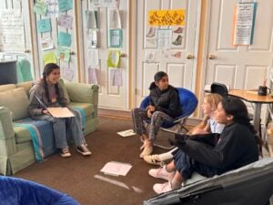 Students having a group discussion in classroom.
