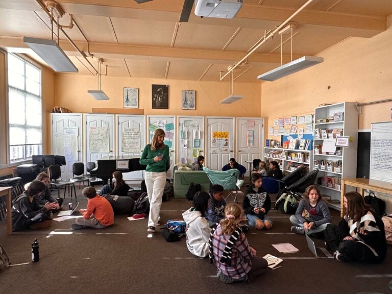 Students and teacher in classroom discussion.