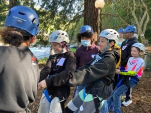 Kids in helmets participating in outdoor team activity.
