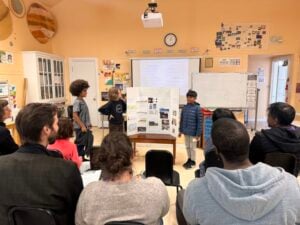 Students presenting project to classroom audience