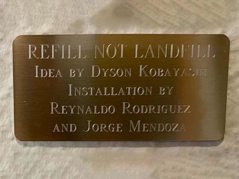 Plaque reads 'Refill Not Landfill' with creators' names.