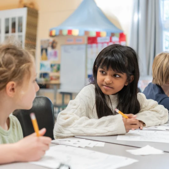 Crowden students studying and discussing in a classroom.