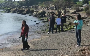 Group studying rocky shoreline environment.