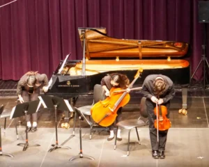 Musicians bowing on stage after performance.