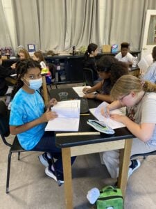 Students working on classroom science project together.
