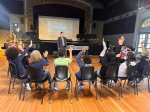 Teacher engaging students in classroom discussion.