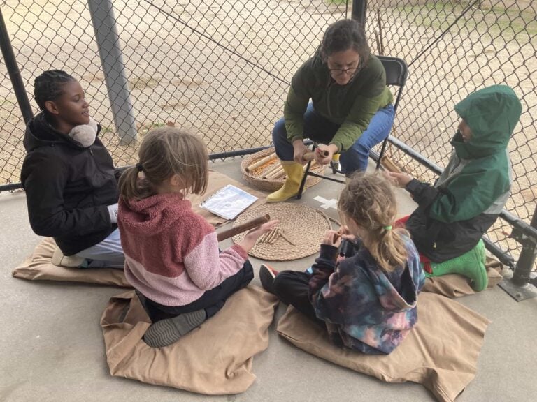 Children learning hands-on crafting outdoors