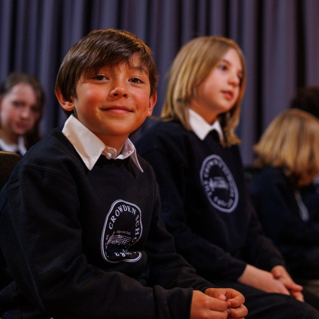Crowden students in uniform during school assembly.