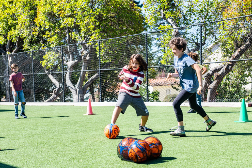 Crowden students playing soccer on a sunny day