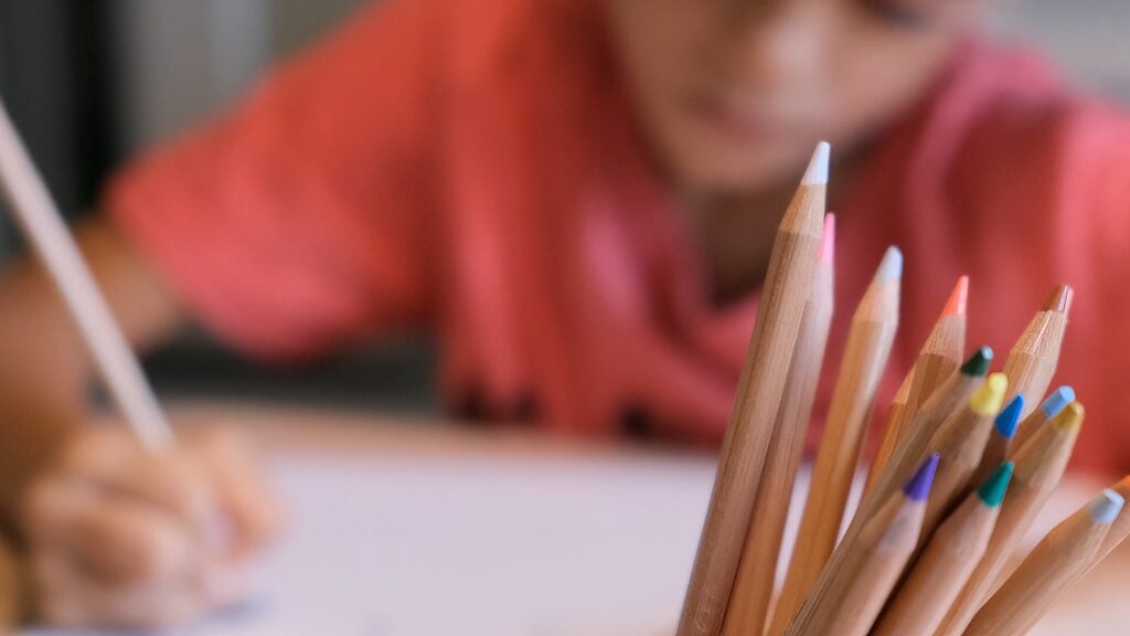 Crowden student drawing with colored pencils on paper