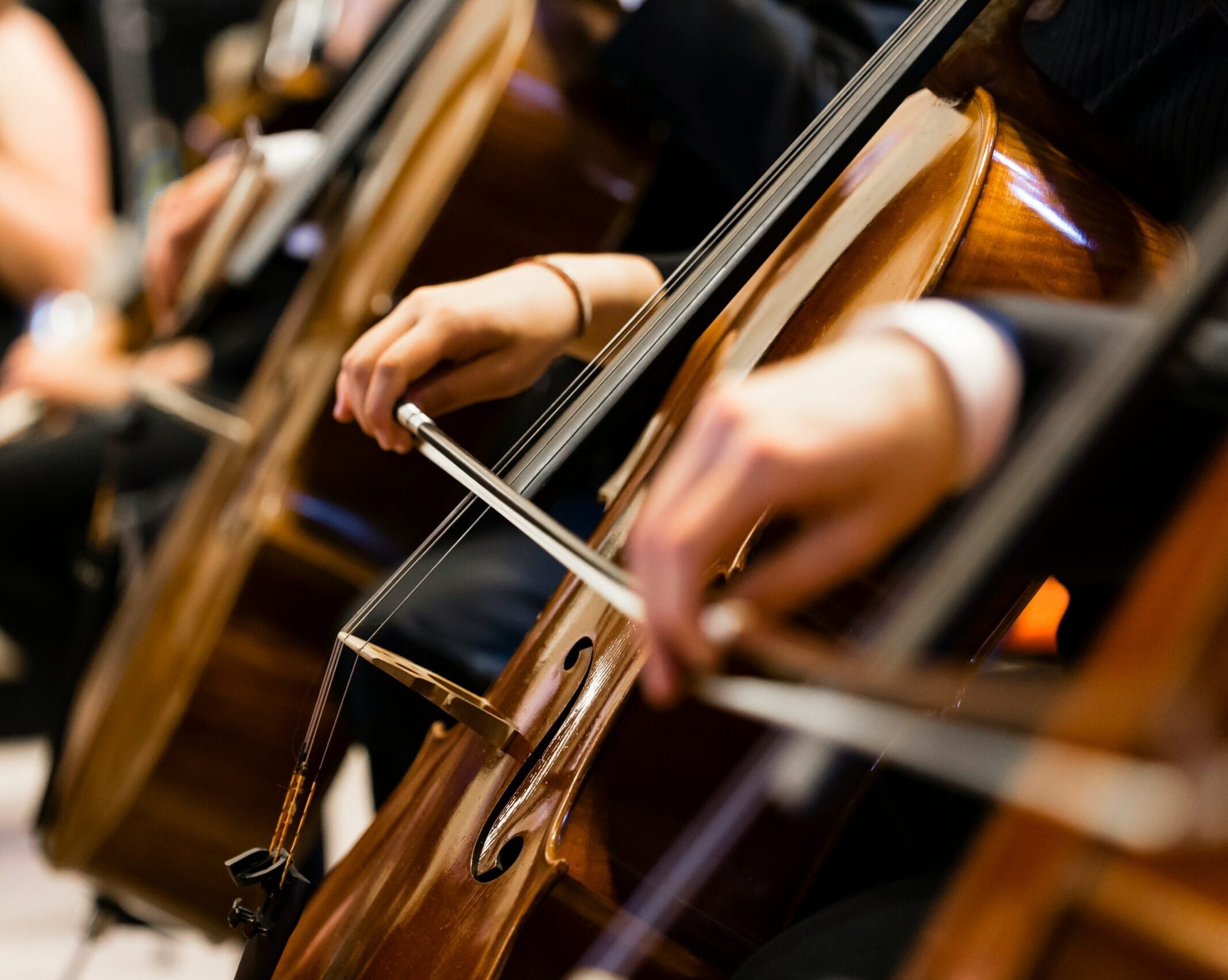 Motion-blurred violinists performing with bows and strings